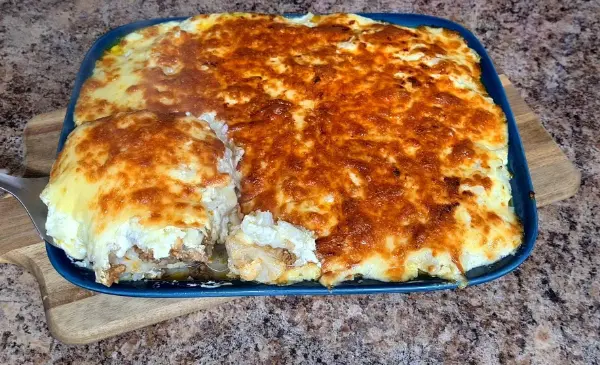 Creamy and cheesy cauliflower casserole in a baking dish with a golden brown top.