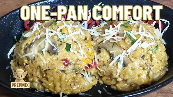 A plate of creamy mushroom rice topped with melted cheese and parsley, served in a black skillet for the perfect cozy one-pan dinner.