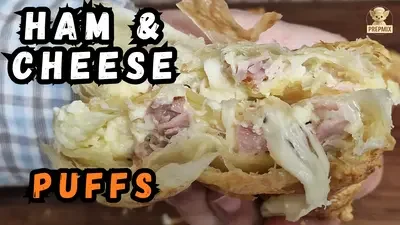 Golden homemade ham and cheese puff pastries with a crispy flaky outside and creamy cheese filling.