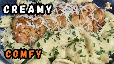 Creamy Parmesan shell pasta topped with juicy pan-seared chicken, fresh parsley and grated Parmesan.