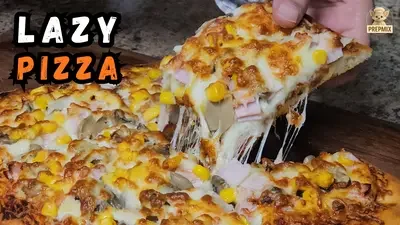 Homemade lazy air fryer pizza topped with melted mozzarella, smoked ham, mushrooms and sweetcorn, with a golden baked crust.